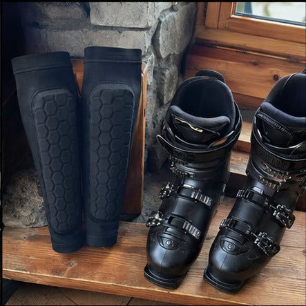 Black Alpine Guards arranged next to a pair of ski boots